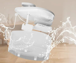 White cat water fountain taken apart into lid, pump unit with cable, and tank, with water splashing around it
