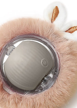 Close-up of a rolling ball held in a fluffy plush cover with two bunny ears, its power button on the front