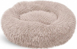 Empty round beige-brown shaggy donut bed with a raised rim, on white
