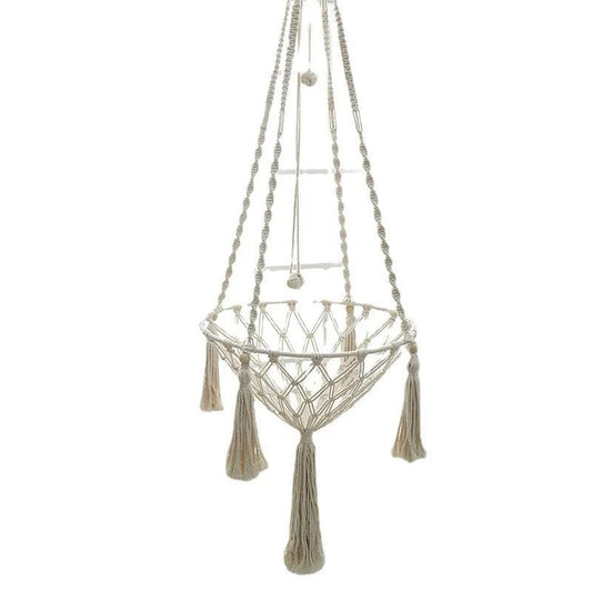 Cream knotted rope cat hammock with tassels, hanging empty, with a separate hanging cord with two knotted rope balls, on white