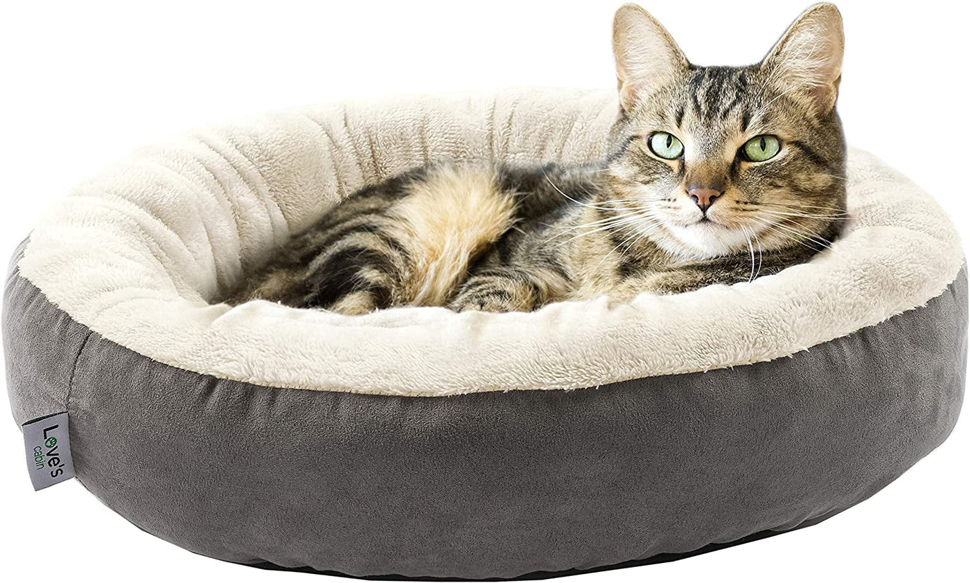 Tabby cat curled inside the grey donut cuddler bed