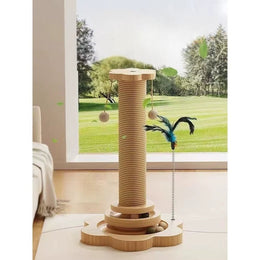 Rope-wrapped cat scratching post on a wooden flower-shaped base with a two-tier ball track, two hanging rope balls and a feather teaser on a spring, by a window