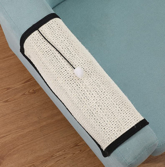Cat scratching the sisal mat on a couch arm