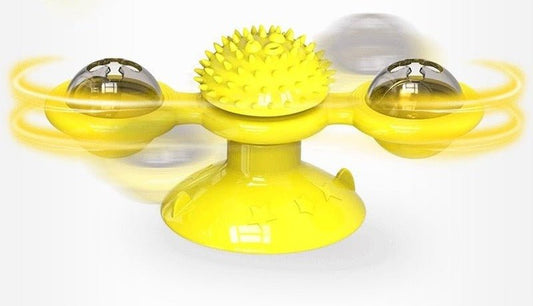 Yellow windmill toy on a suction-cup base, its arm with two clear domes shown spinning