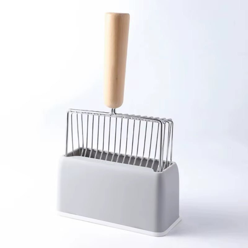 Metal wire litter scoop with a wooden handle, standing head-down in a grey holder on a white base